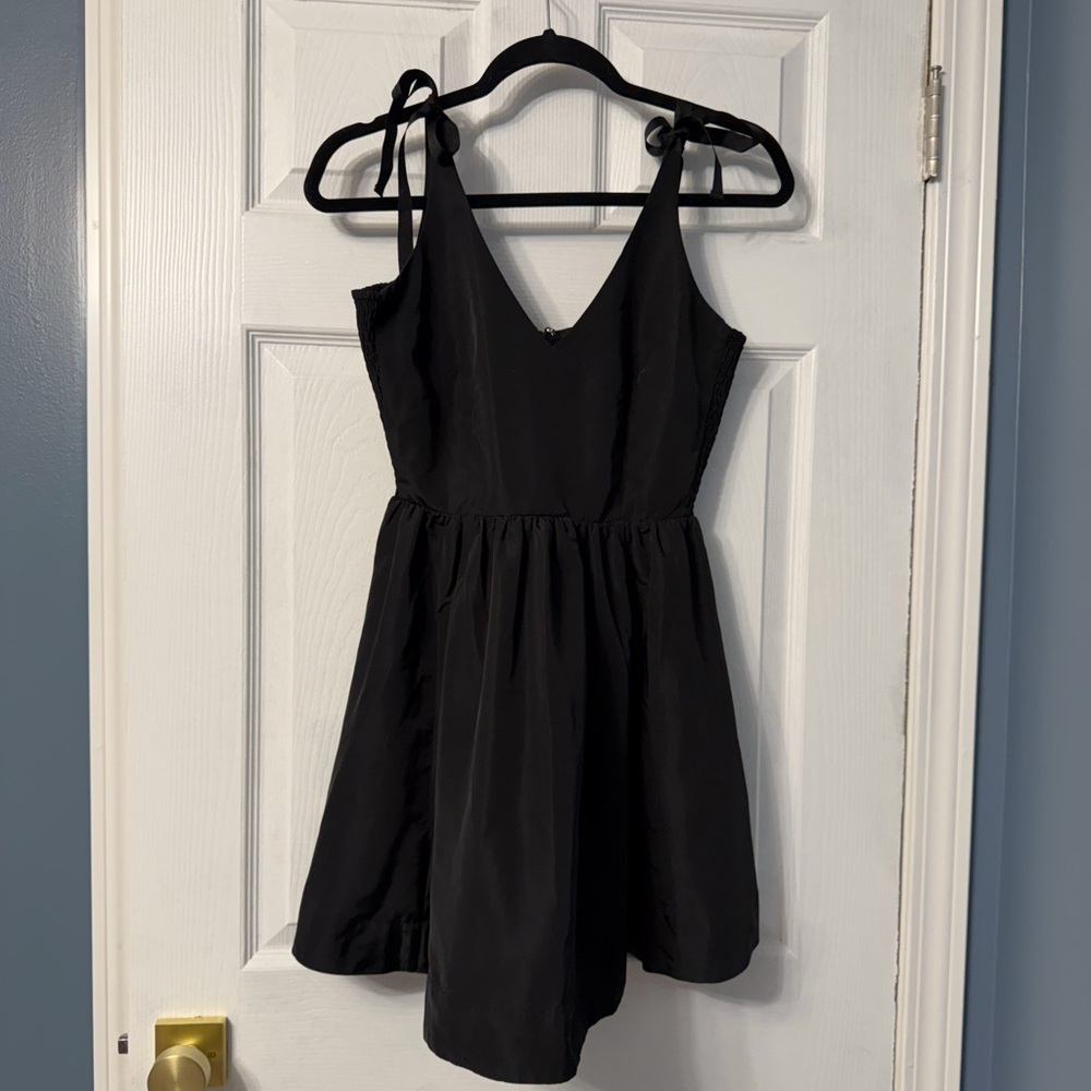 Old Navy black fit and flare dress with ties at the straps, has stretchy